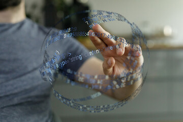 A person touching a digital interface with floating data, code, representing technology and connection.