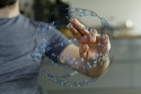A person touching a digital interface with floating data, code, representing technology and connection.