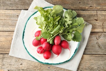 Fresh ripe radishes on wooden table, top view