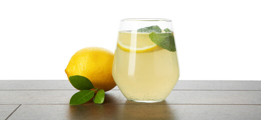 Tasty lemonade with mint and fresh fruit on wooden table against white background