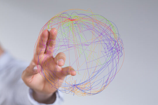 An image of a hand interacting with lines forming a sphere, concept of global connection and technology.