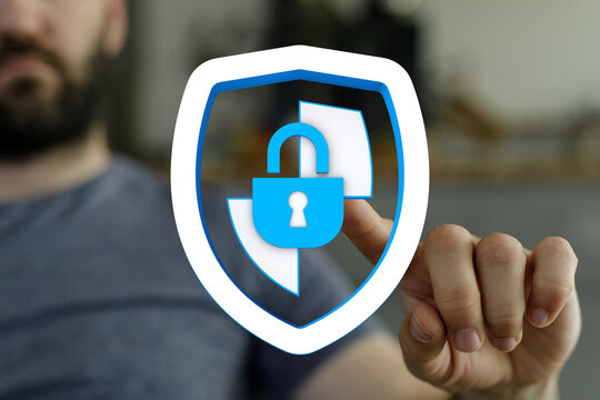 A man's hand interacts with a digital shield icon featuring a padlock, symbolizing data protection, security, and online safety. The