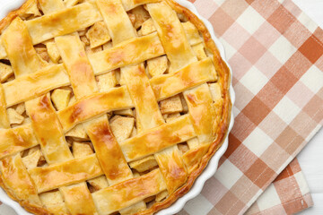 Delicious homemade apple pie on white wooden table, top view. Space for text