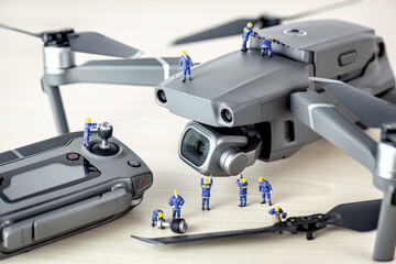 Engineers maintaining and repairing a drone with camera