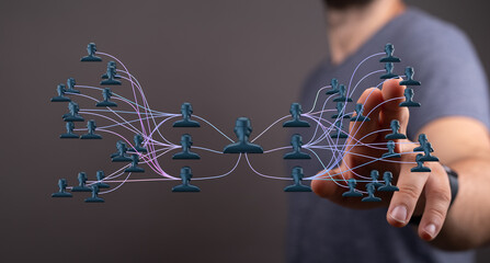 Abstract image showing interconnected human icons and a person interacting with the digital world, representing networking and business connecti