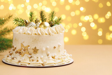Delicious cake with Christmas decor on beige background against blurred lights, space for text. Bokeh effect