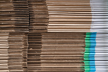 Stack of cardboard boxes. Eco-friendly recyclable materials ready for shipment, distribution. Pile of flat cardboard boxes prepared for assembly at industrial warehouse. Sustainable manufacturing.