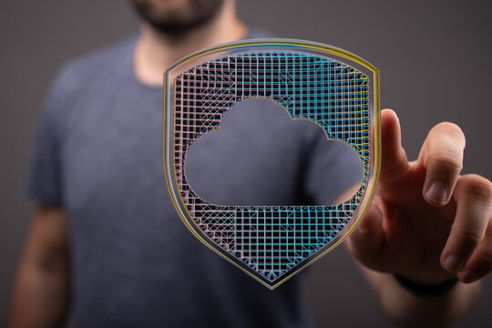 Concept of cybersecurity and cloud computing. Hand holding shield with cloud shape. Digital data protection. Security, online safety,