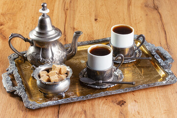 cup of coffee and vintage coffeepot on wooden table