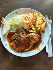 A delectable grilled steak served with a fresh garden salad, featuring vibrant greens