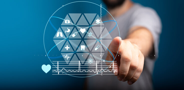 Modern healthcare technology concept.  Man interacts with a digital interface showing medical icons and data.