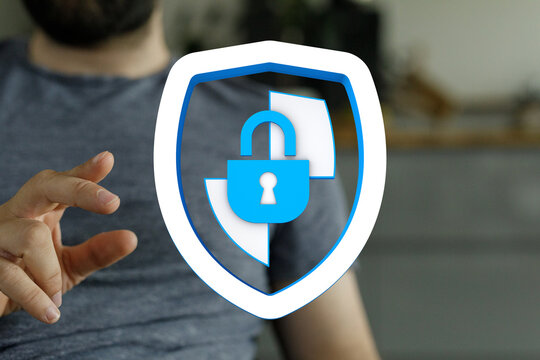 Concept of cybersecurity, data protection and digital privacy. Hand interacting with a shield and padlock icon to symbolize secure ac