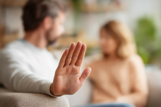 Hands on couch armrest with defocused domestic conflict scene, faceless marital crisis, relationship breakdown visualization, blurred living room, divorce stress detail, couple arg