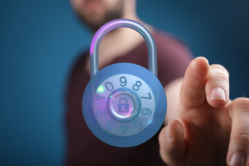 A person's hand touching a glowing padlock dial representing digital security and online protection, data safety, and password encryp