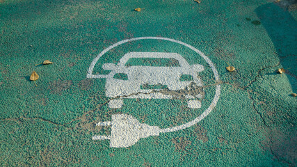 Electric vehicle charging parking sign painted on asphalt