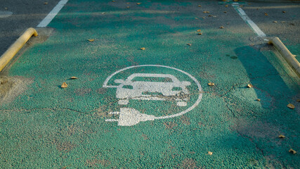 Electric vehicle charging parking sign painted on asphalt