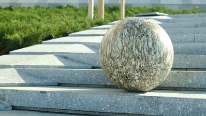 marble sphere placed on architectural platform outdoors
