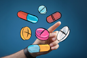 Hand interacting with colorful medication.  Perfect for healthcare, pharmacy, medicine concepts.