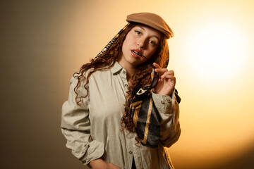 Young woman posing with hat and curly hair