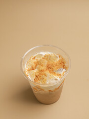 A glass of coffee with milk or cream