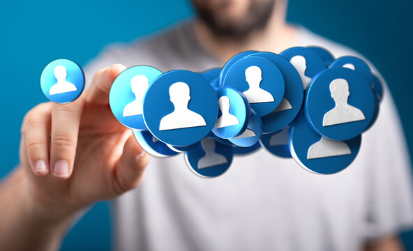 Close-up of hand touching a collection of person icons, symbolizing social networks, community, and digital interactions. Ideal for illustrating