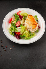 Grilled chicken breast salad chicken breast tomato, green leaf lettuce, salad mix snack vegetables natural product tasty snack fresh gourmet food background on the table rustic top view copy space