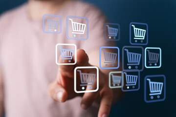 Person interacting with digital shopping cart symbols. Ecommerce and online retail concept. Focus on digital cart icons, business and purchases.