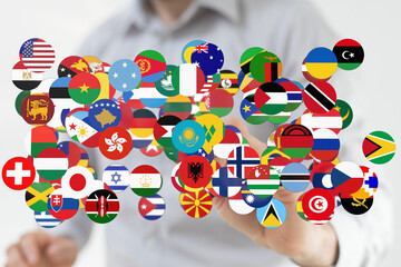 Conceptual image of a hand holding various flags representing countries, symbolising global unity,...