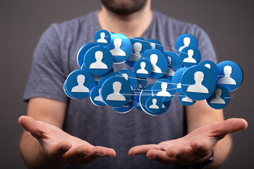 Concept of social network and global connections visualized. A man holding network icons represents human relationships and digital community.