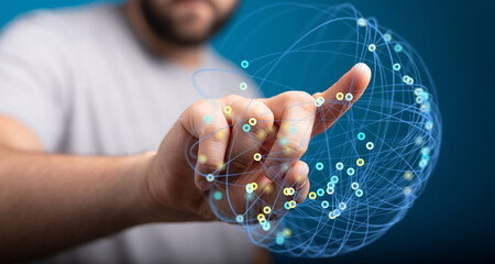 Close-up of a hand pointing at a glowing digital globe representing global connections and network...