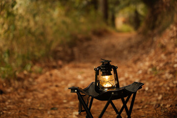 Autumn forest, lantern light, camping