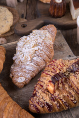 Various types of desserts and pastries on an old wooden background