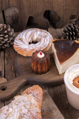 Various types of desserts and pastries on an old wooden background