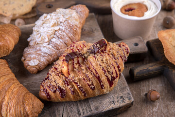 Various types of desserts and pastries on an old wooden background