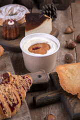 Various types of desserts and pastries on an old wooden background