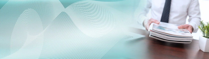 Man holding magazines; panoramic banner