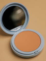 Compact pressed powder with mirror in blue container