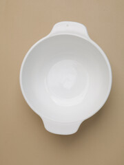 Ceramic bowl or container on beige background