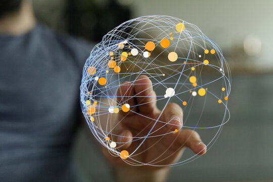 Close-up of a hand touching a digital globe, symbolizing global connections, data transfer, and technological progress. Suitable for