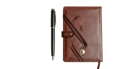 Elegant black writing instrument rests beside a detailed brown leather bound journal against a dark background