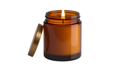 Lit fragrance vessel with unattached metallic cover rests against the side in darkness