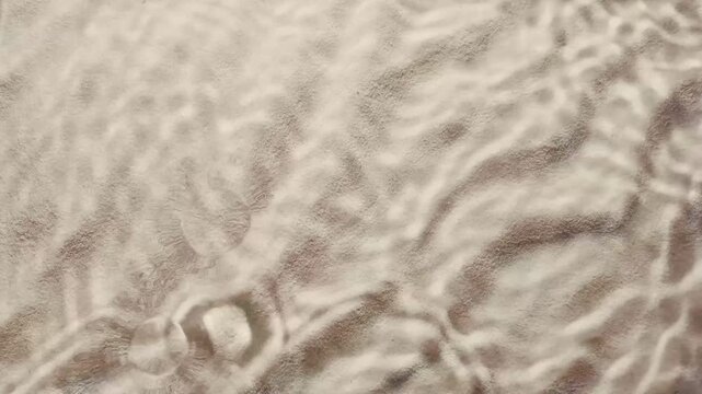 drops splashing onto sandy background, evoking feelings of relaxation, suitable for spa and cosmetic marketing in slow motion, copy space