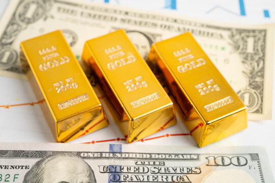 Gold bars with US dollar and Euro banknote money, finance trading investment business currency.