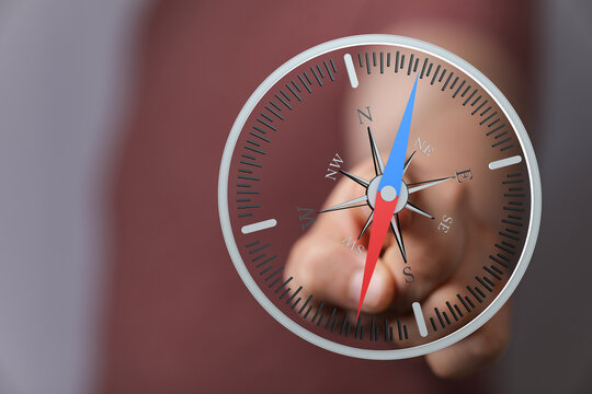 Hand holding a compass for direction. Navigation and leadership concepts, guide through choices, future planning, inspiration and travel explora - Powered by Adobe
