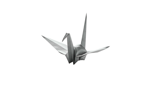 Folded paper bird figure floats against a dark background in monochrome lighting