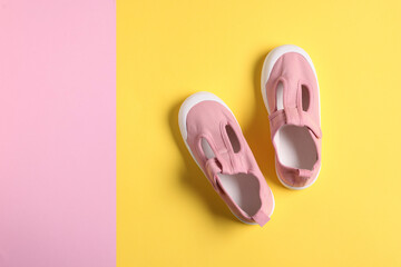 Pair of stylish kid's shoes on color background, flat lay. Space for text