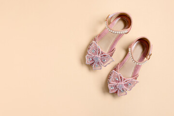 Pair of stylish kid's shoes on beige background, flat lay. Space for text