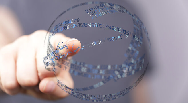 Person's finger interacting with a holographic sphere representing internet connection, data transfer and digital information.