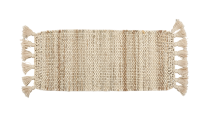 Handwoven textured floor covering featuring decorative tassels at the ends is displayed against a dark background.