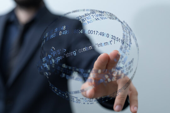 A businessperson's hand interacts with a digital data sphere representing the interconnectedness of modern technology, ideal for IT a